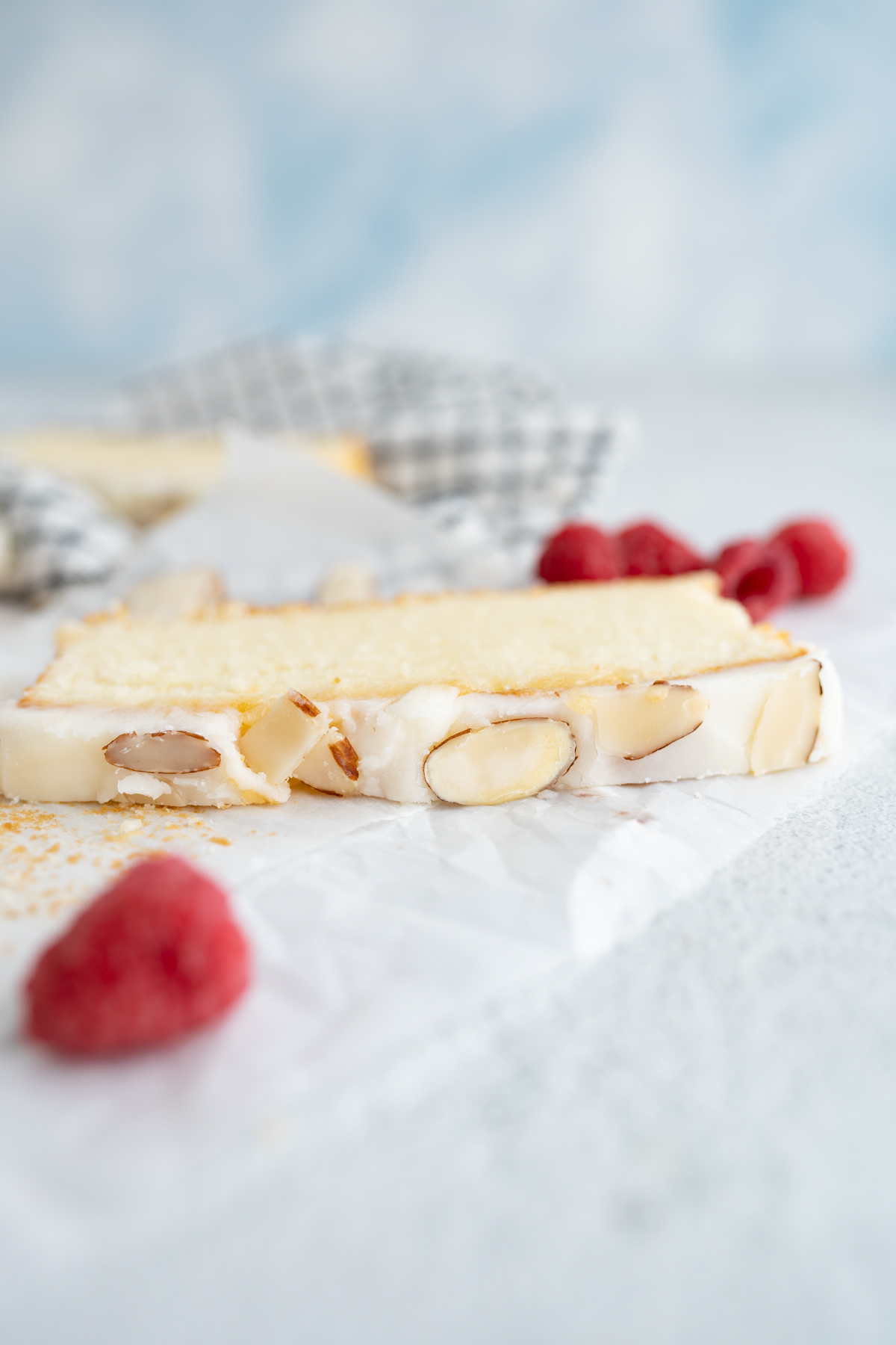 Top view of almond pound cake with almond glaze and sliced almonds. 