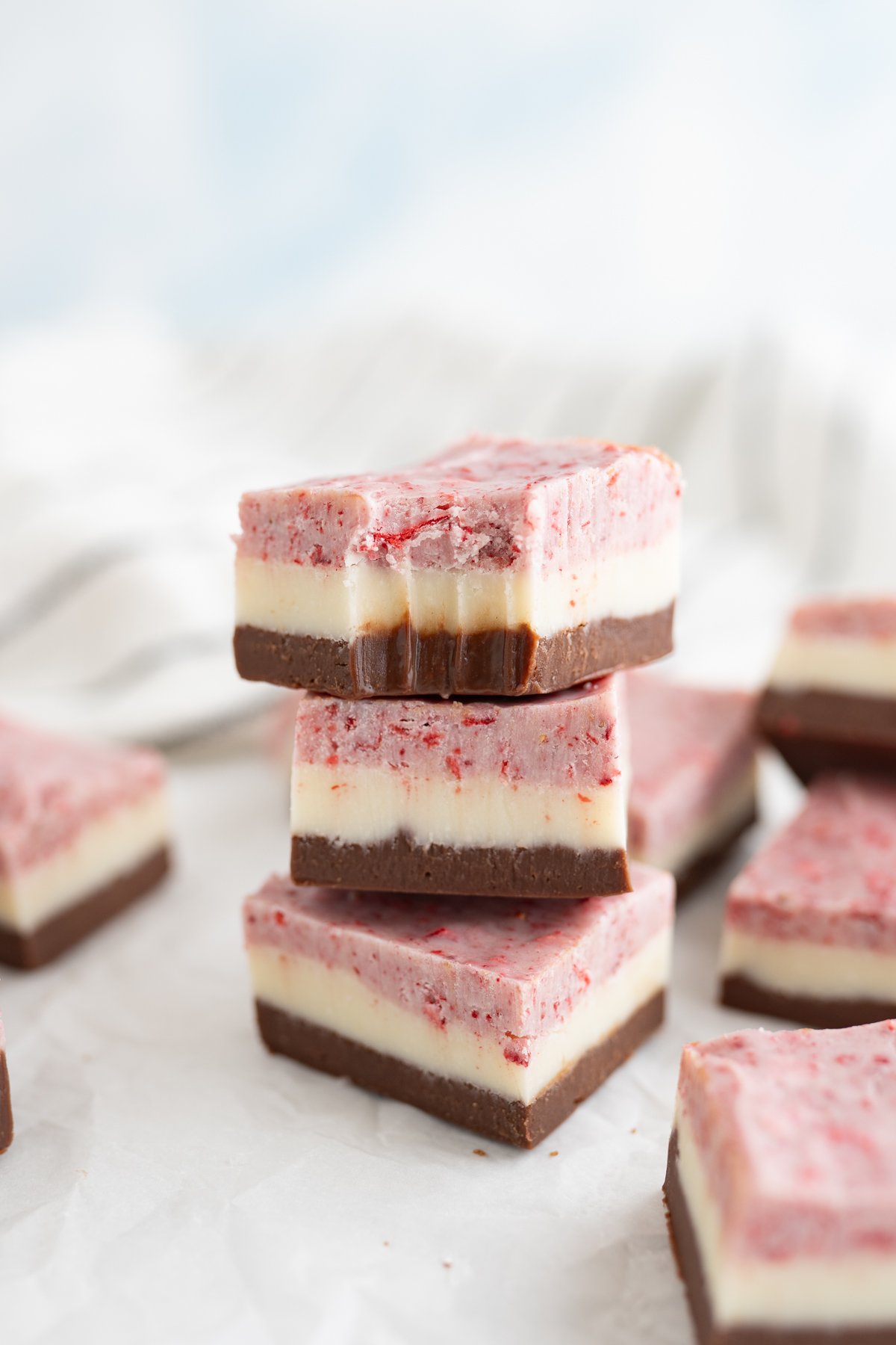 A neapolitan fudge square with a bite taken out. 