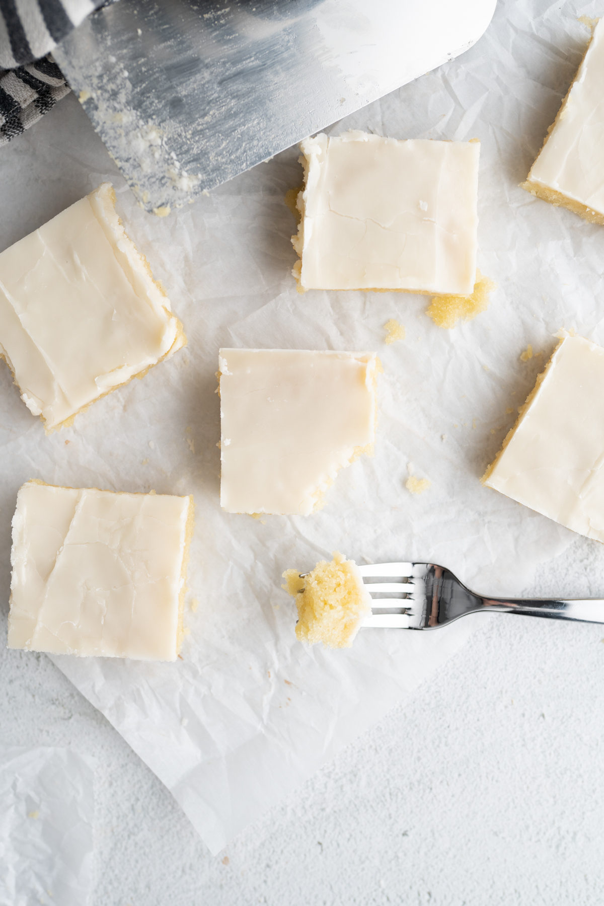 Aerial view of vanilla sheet cake slices on the counter. 