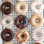 Aerial view of homemade donuts on a wire cooling wrack.