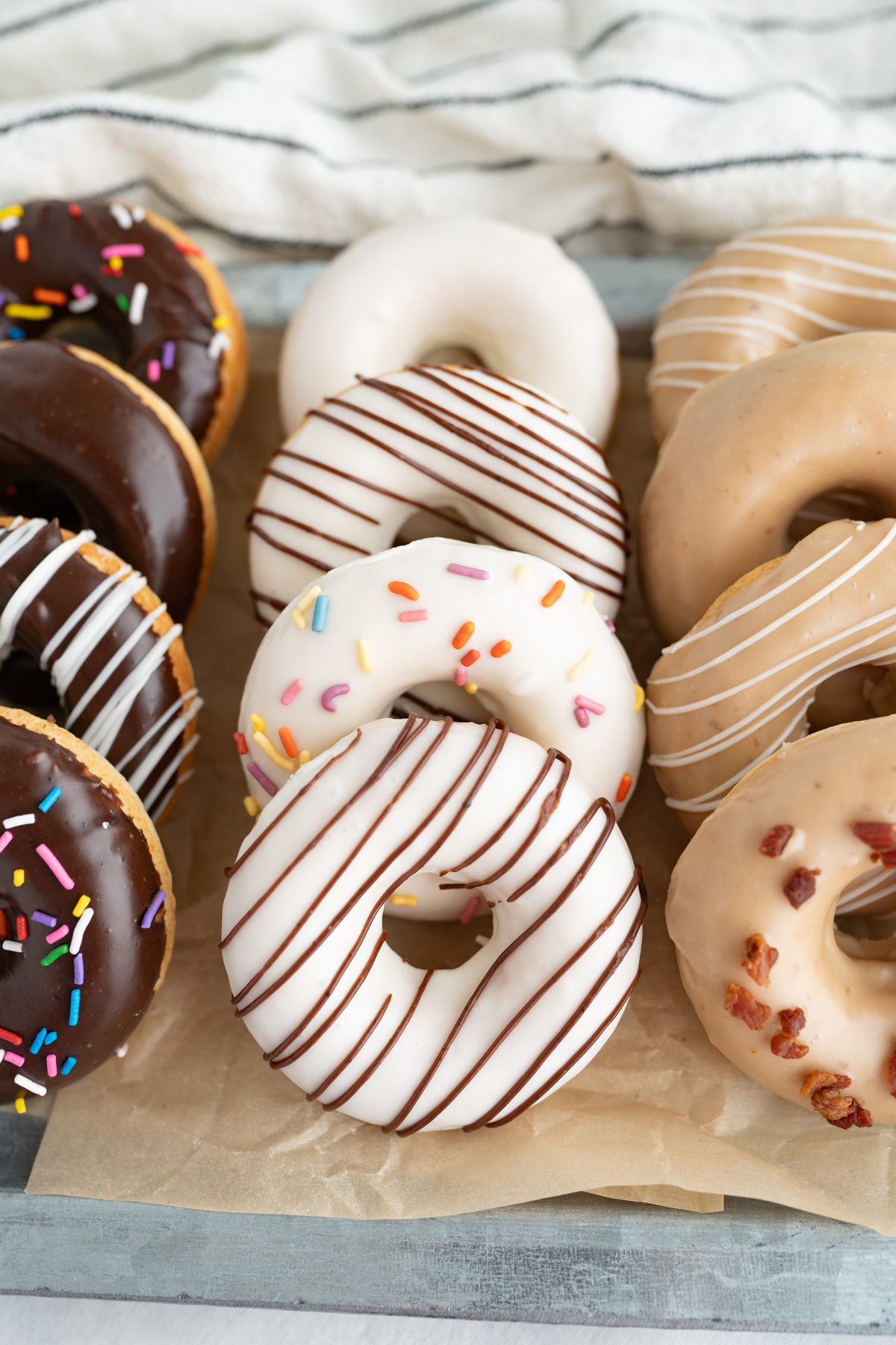 Baked cake donuts with chocolate icing, white icing, or maple icing. 