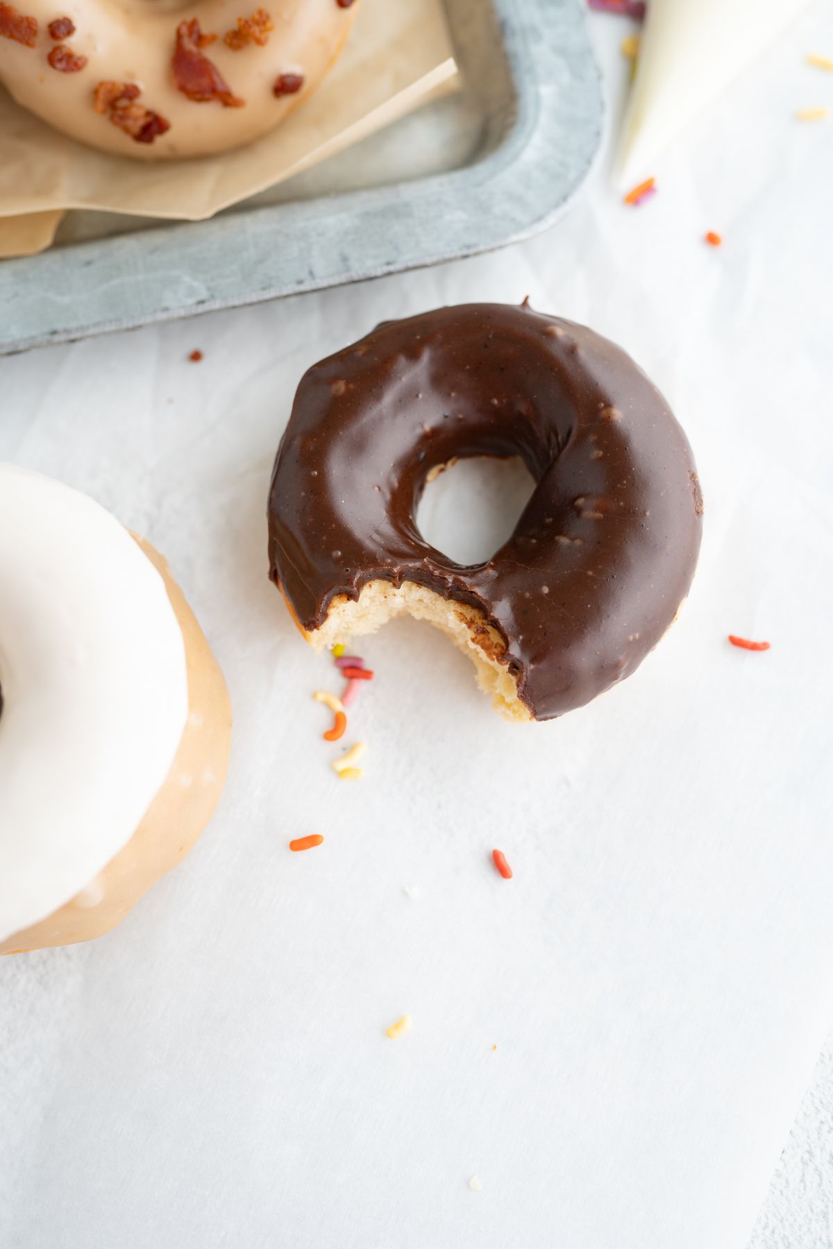 Aerial view of a homemade cake donut with a bite taken out of it. 