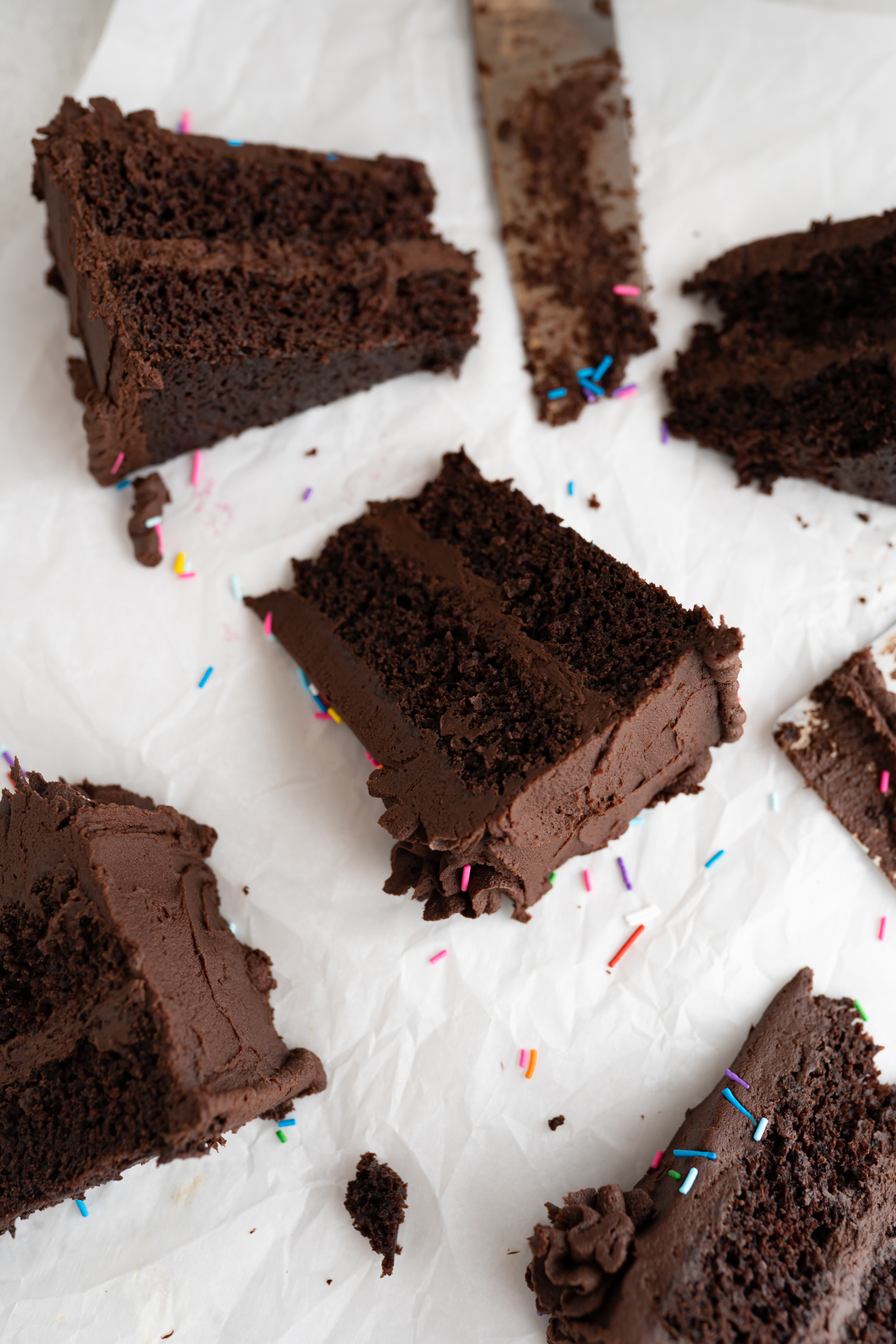 Slices of chocolate birthday cake on the counter. 