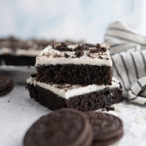 Two slices of Oreo Texas Sheet Cake stacked.