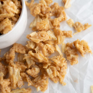 Salty + sweet potato chip candy falling out of a bowl.